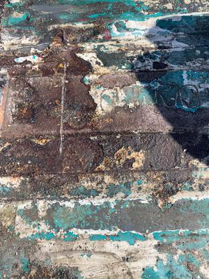 Here is a photo of a rusty container before treatment